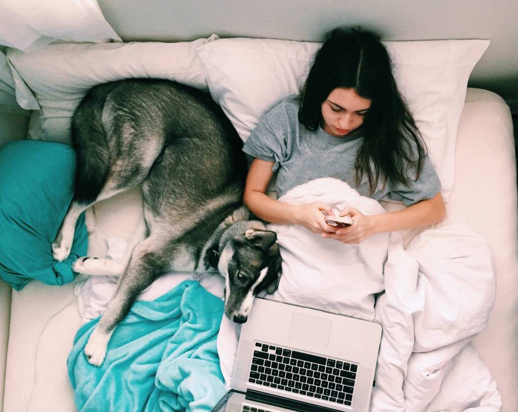 girl in bed with dog