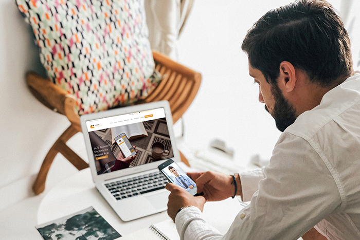 man on his phone with the online doctor