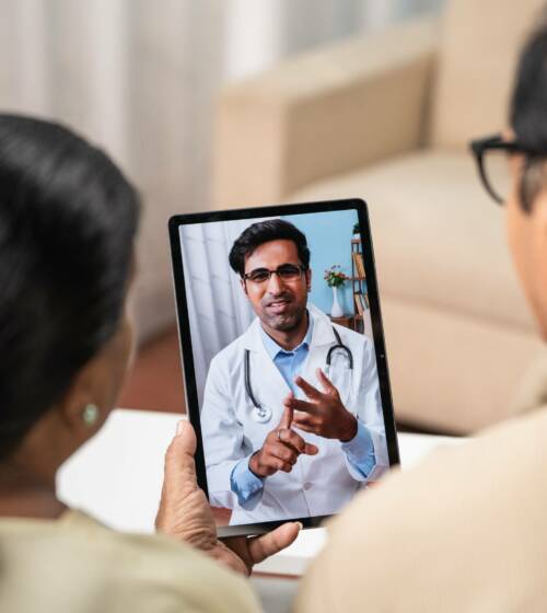 Shoulder,Shot,Of,Indian,Senior,Couple,Taking,Advice,From,Doctor Instant Consult doctor on the app