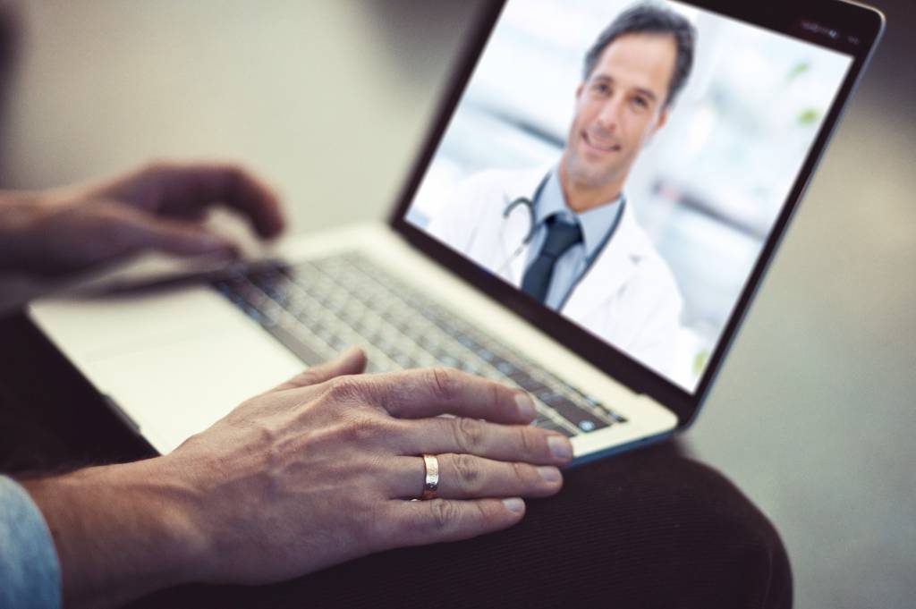 online telehealth professional on laptop screen